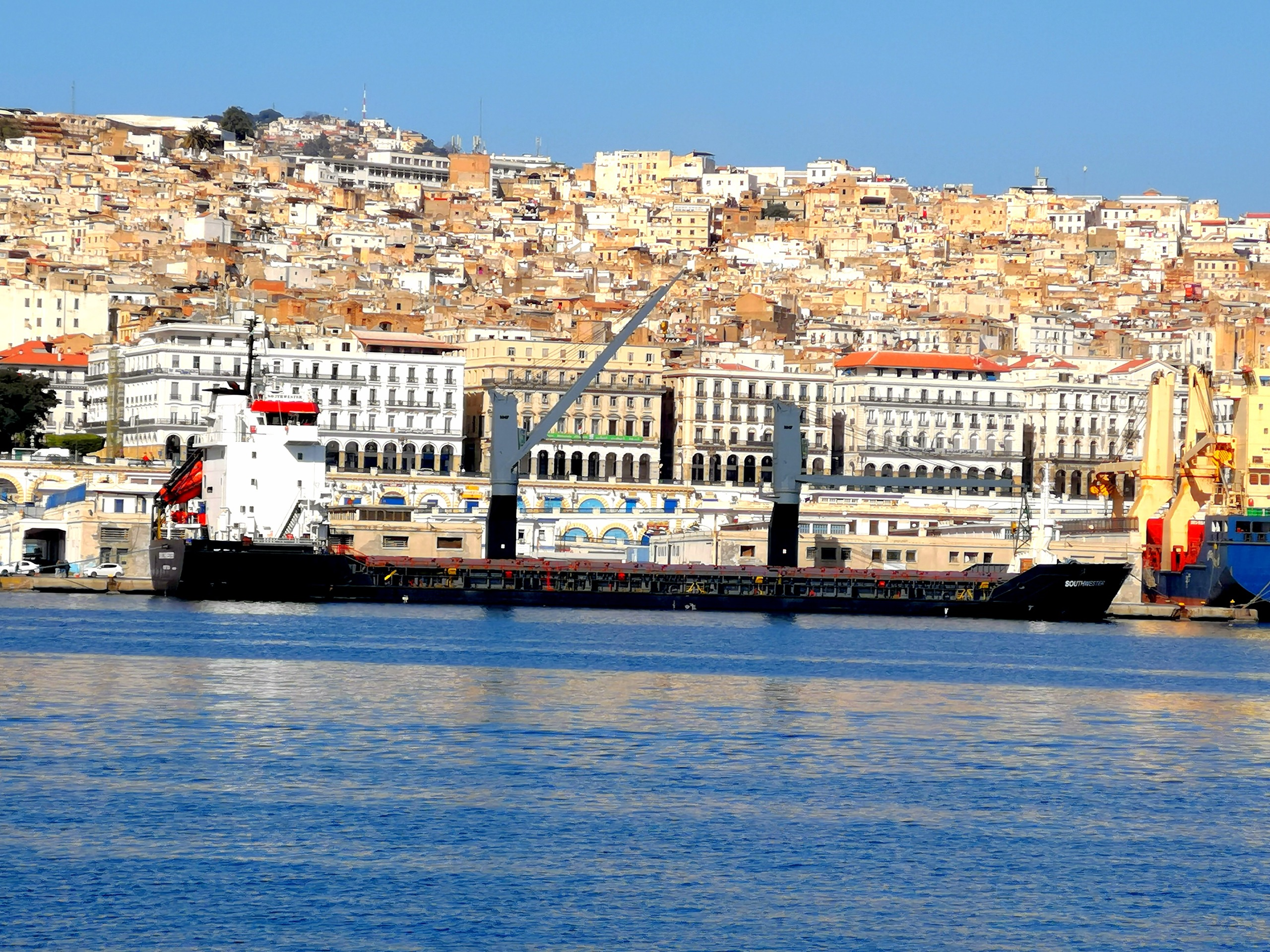 The port of Algiers below the Casbah, with a cargo ship alongside